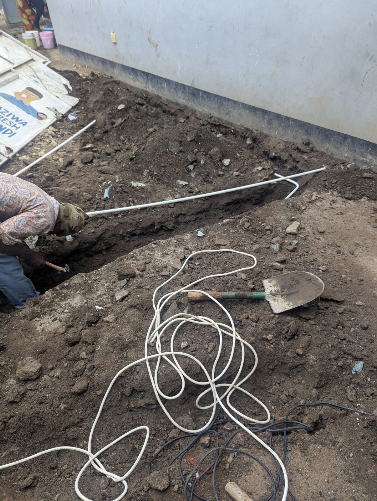 Digging a protective trench for the underground electrical cable