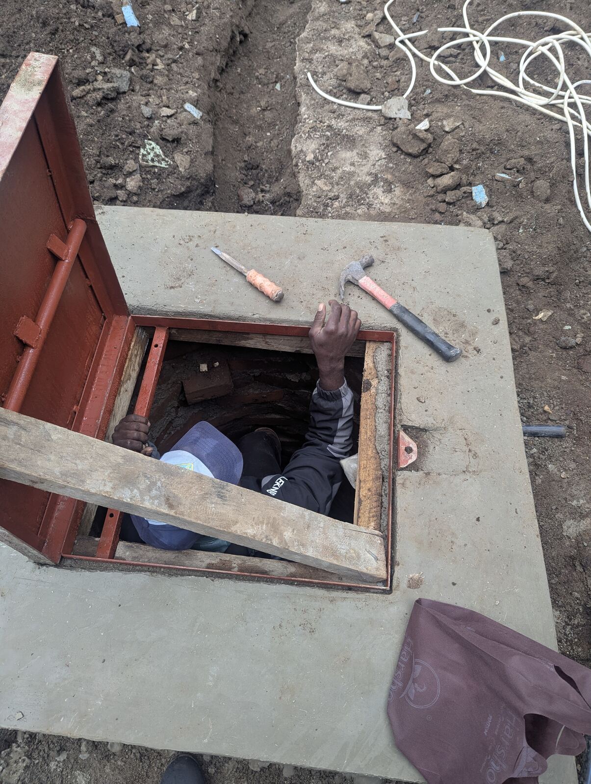 The well housing opened up so the team could finish wiring the pump from inside