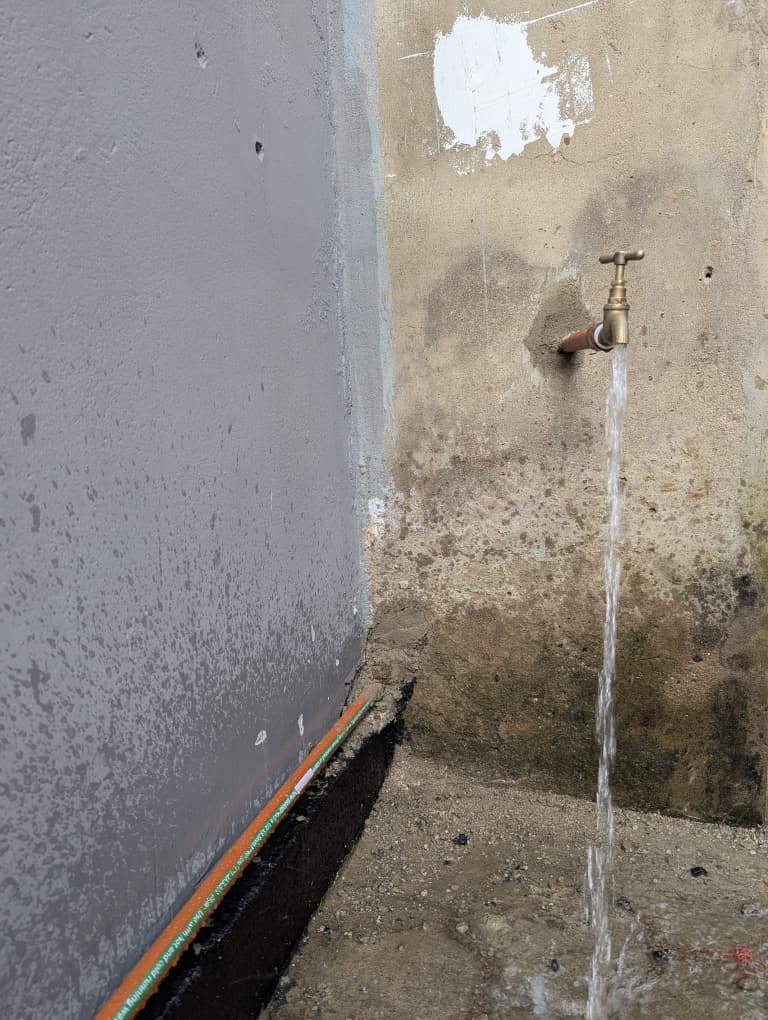 Water running freely from the tap at the finished well