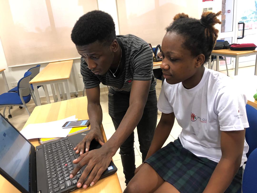 Volunteer helping student with computer problem